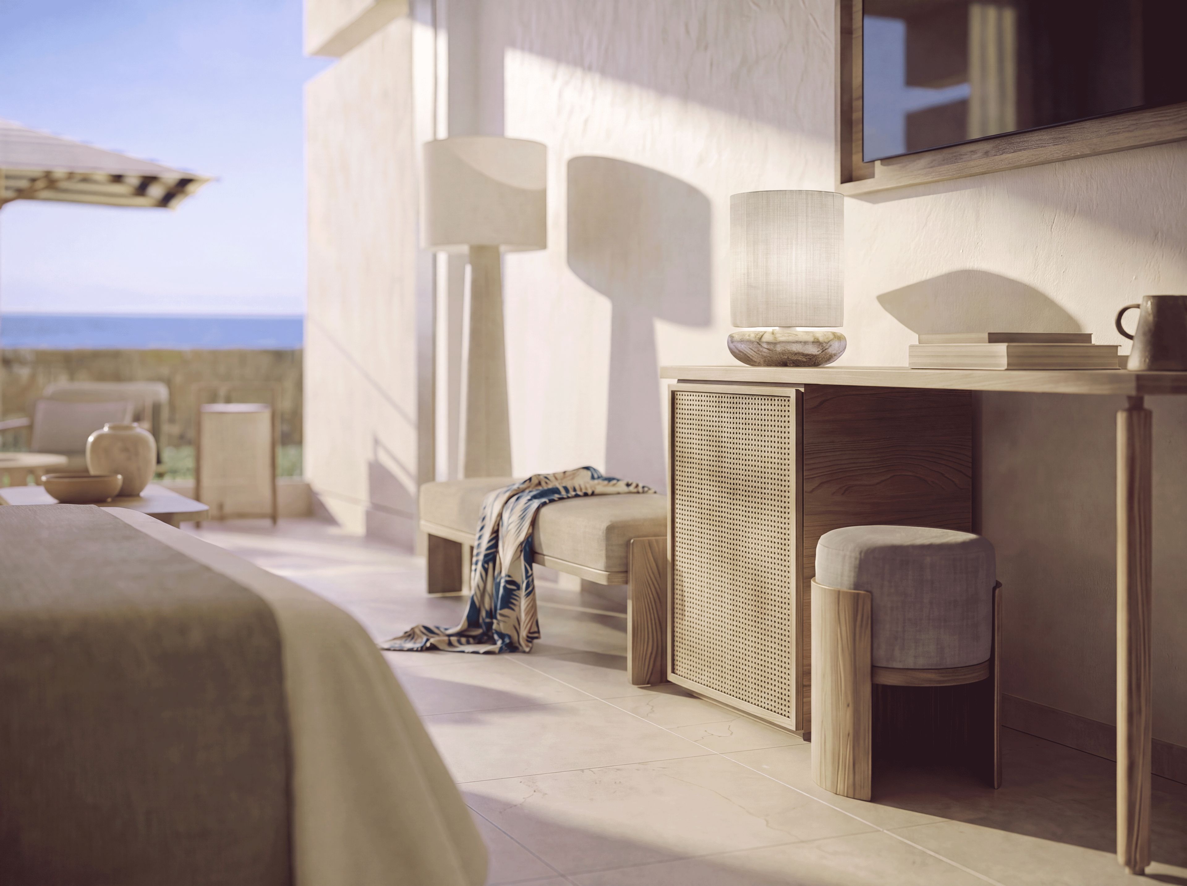 Une chambre d’hôtel moderne avec un grand lit, un coin salon comprenant une chaise et une table, une petite table d’appoint et un grand miroir au mur.