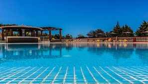 A clear blue pool with tiled flooring, a gazebo, and lounge chairs along the poolside. - Colina da Lapa & Villas (Lagoa)
