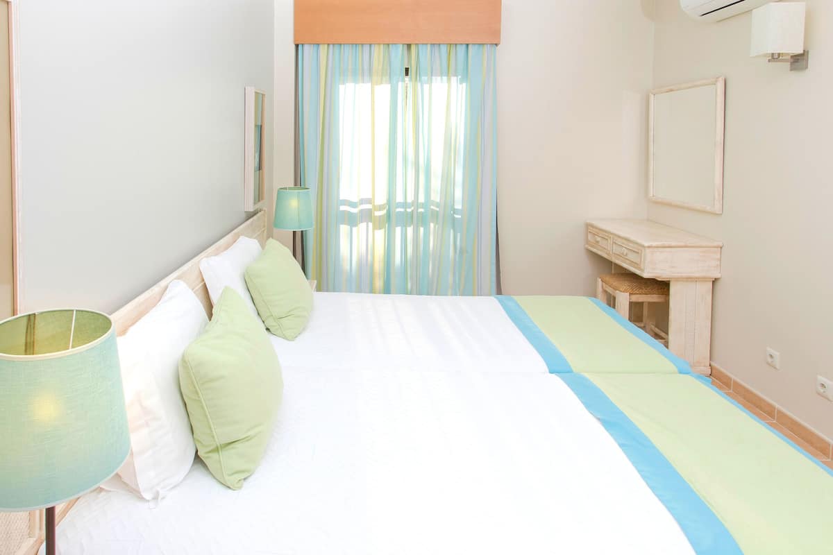 Apartment, 1 Bedroom, Resort View | 1 bedroom, in-room safe, blackout curtains, iron/ironing board