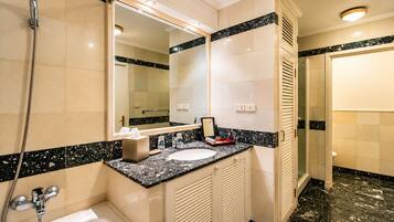 A bathroom with a bathtub, a sink, a mirror, and a shower.