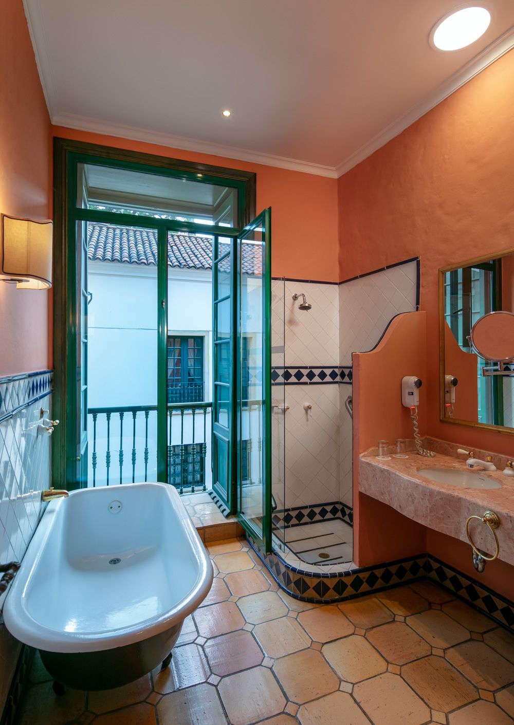A bathroom with a bathtub, a shower, and a sink.