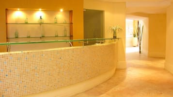 Welcome to our reception area, featuring a sleek glass partition, a modern reception desk, and a beautiful mosaic floor.