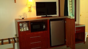A compact kitchenette with a microwave, refrigerator, and a flat-screen TV on a wooden counter. - Royal Motel (Hermitage)