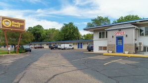 A motel with a sign reading 'Budget Host' and a separate building labeled 'OFFICE'.