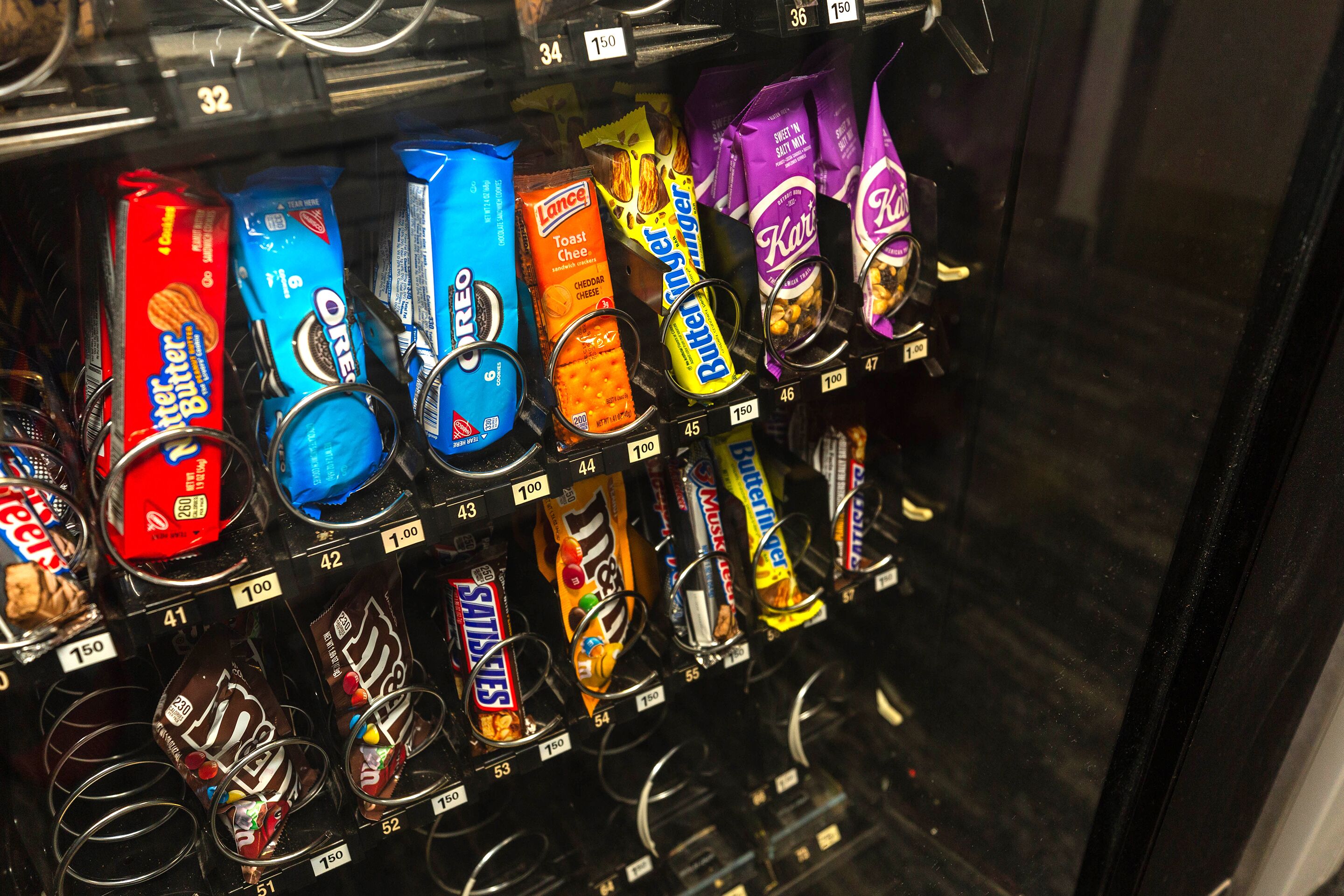 A vending machine stocked with various snack items.