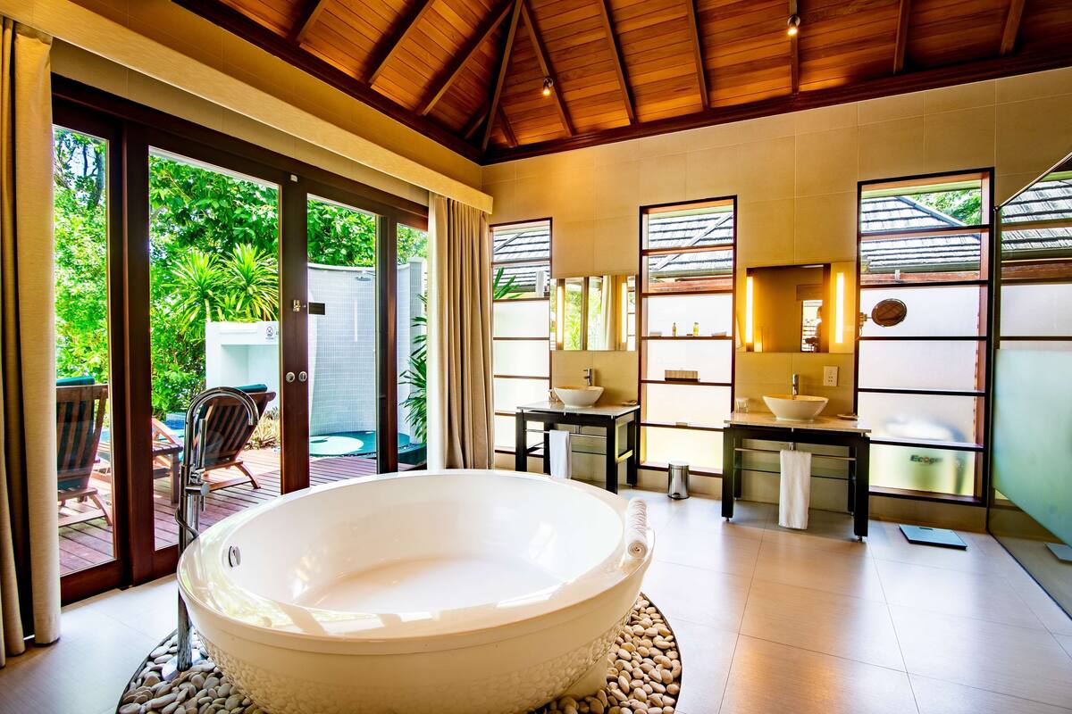 deluxe beachfront pool villa | bathroom | separate bathtub and shower, deep-soaking bathtub, hair dryer, slippers
