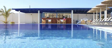 Piscine extérieure, parasols de plage, chaises longues