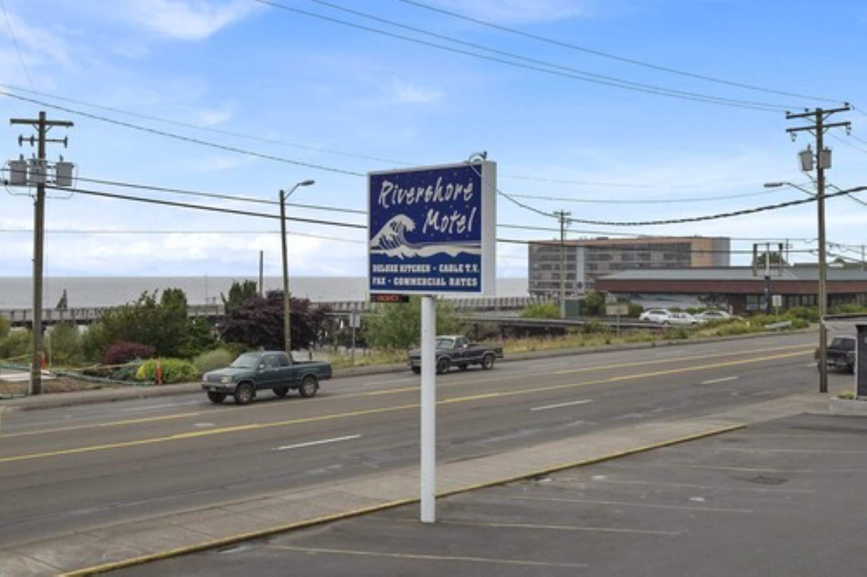 A motel sign with the name 'Riverfork Motel' and mentions 'Full Kitchen - Carlsberg T.V.' and 'Commercial Rates'.