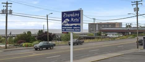 A motel sign with the name 'Riverfork Motel' and mentions 'Full Kitchen - Carlsberg T.V.' and 'Commercial Rates'.