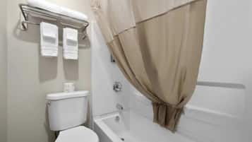 A bathroom with a toilet, a bathtub, and a shower curtain.