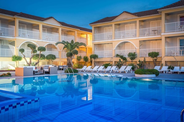 Seasonal outdoor pool, open 10:00 AM to 6:00 PM, pool umbrellas