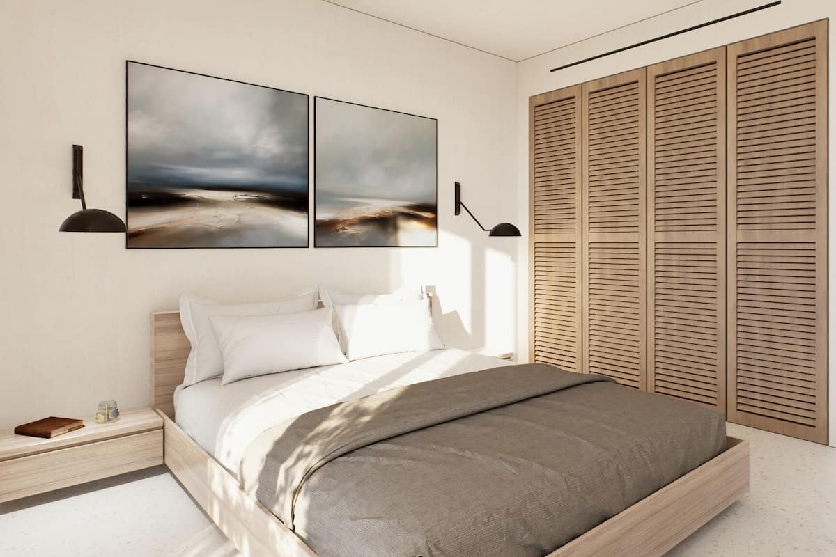 A modern bedroom with a bed, bedside table, and a wardrobe.