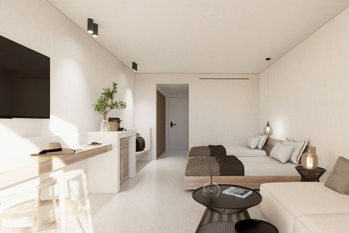 A modern, minimalist living room with a sofa, coffee table, and a flat-screen TV.