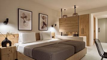 Quarto moderno com uma cama grande, cabeceira de madeira, mesas de cabeceira e um guarda-roupa.