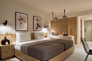 Una camera da letto moderna con un letto grande, una testiera in legno, comodini e un'armadio.