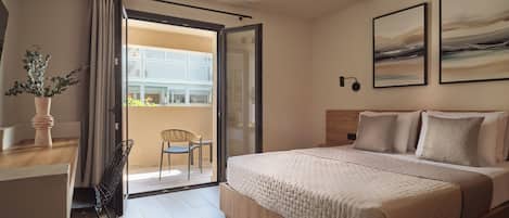 A hotel room with a bed, a chair, a table, a potted plant, and a balcony with a view.