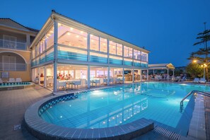 A two-story building with a pool, outdoor seating, and a bar area. - Filoxenia Hotel Zakynthos (Zakynthos)