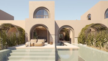 Un edificio moderno con porticati ad arco, una piscina e zone salotto all'aperto.