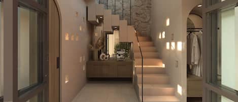 A modern interior with a staircase, a coffee machine, and a plant.