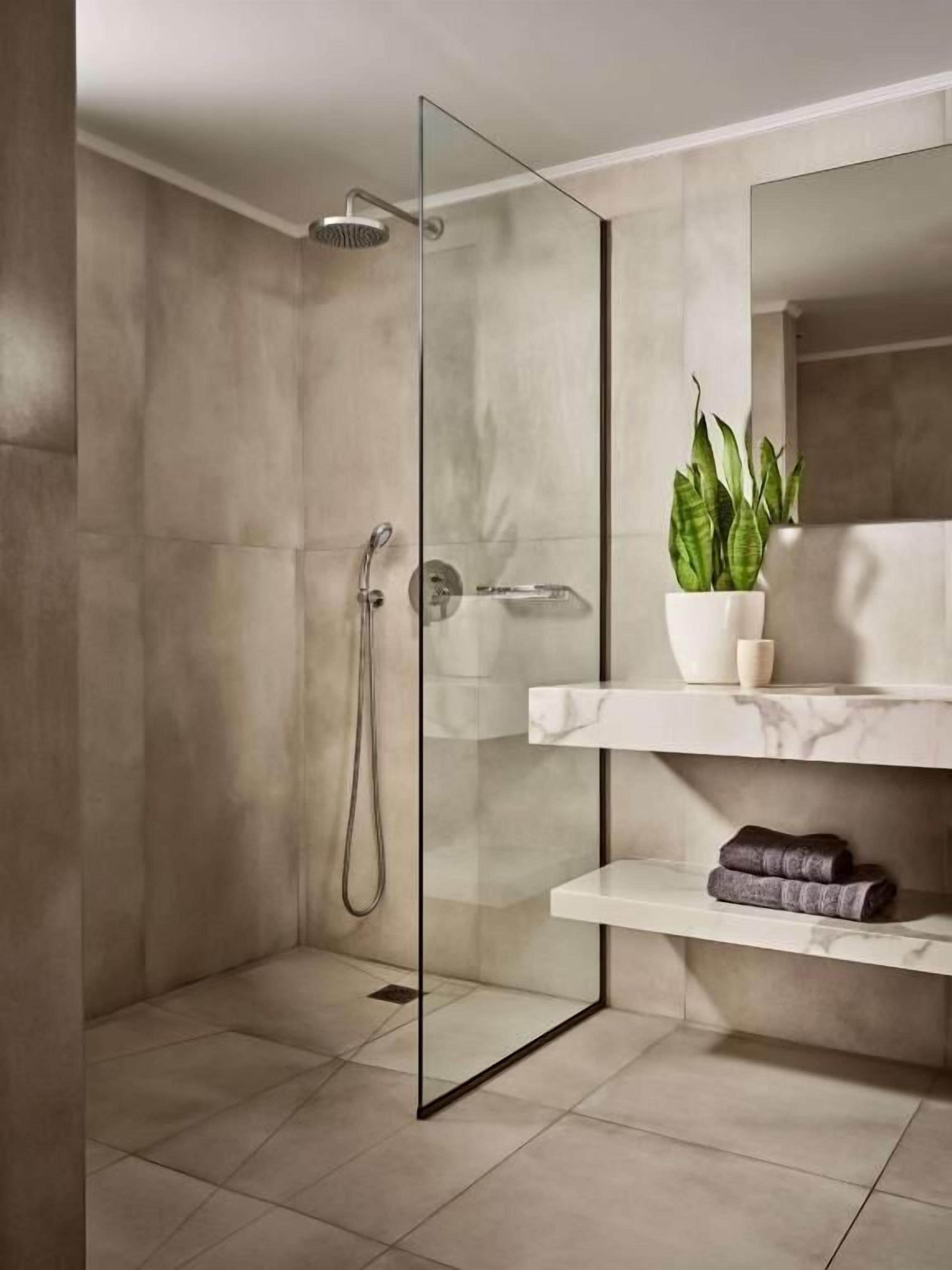 deluxe infinity suite with private pool | bathroom | shower, free toiletries, hair dryer, towels