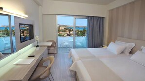 A hotel room with a bed, a desk, a chair, and a TV. - Nestor Hotel (Ayia Napa)