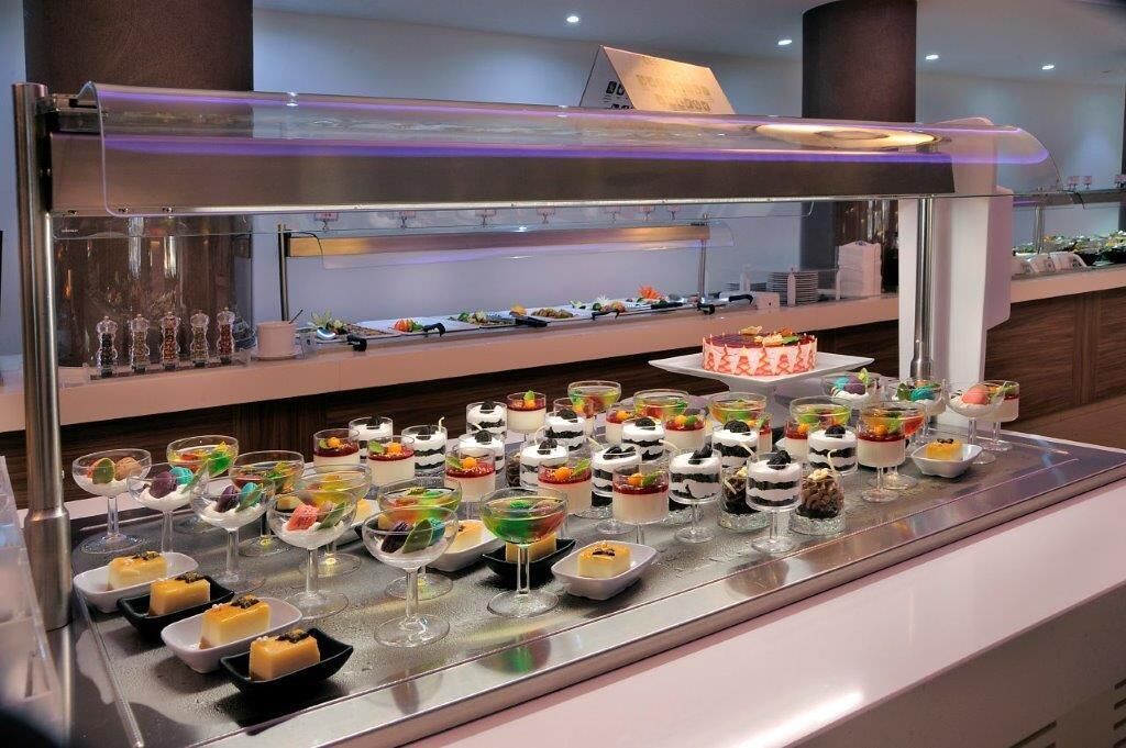 A buffet with various desserts and beverages.