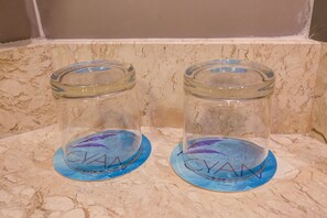 Two glass jars with lids on a marble countertop. - Cyan Resort by Atlantica (Itupeva)