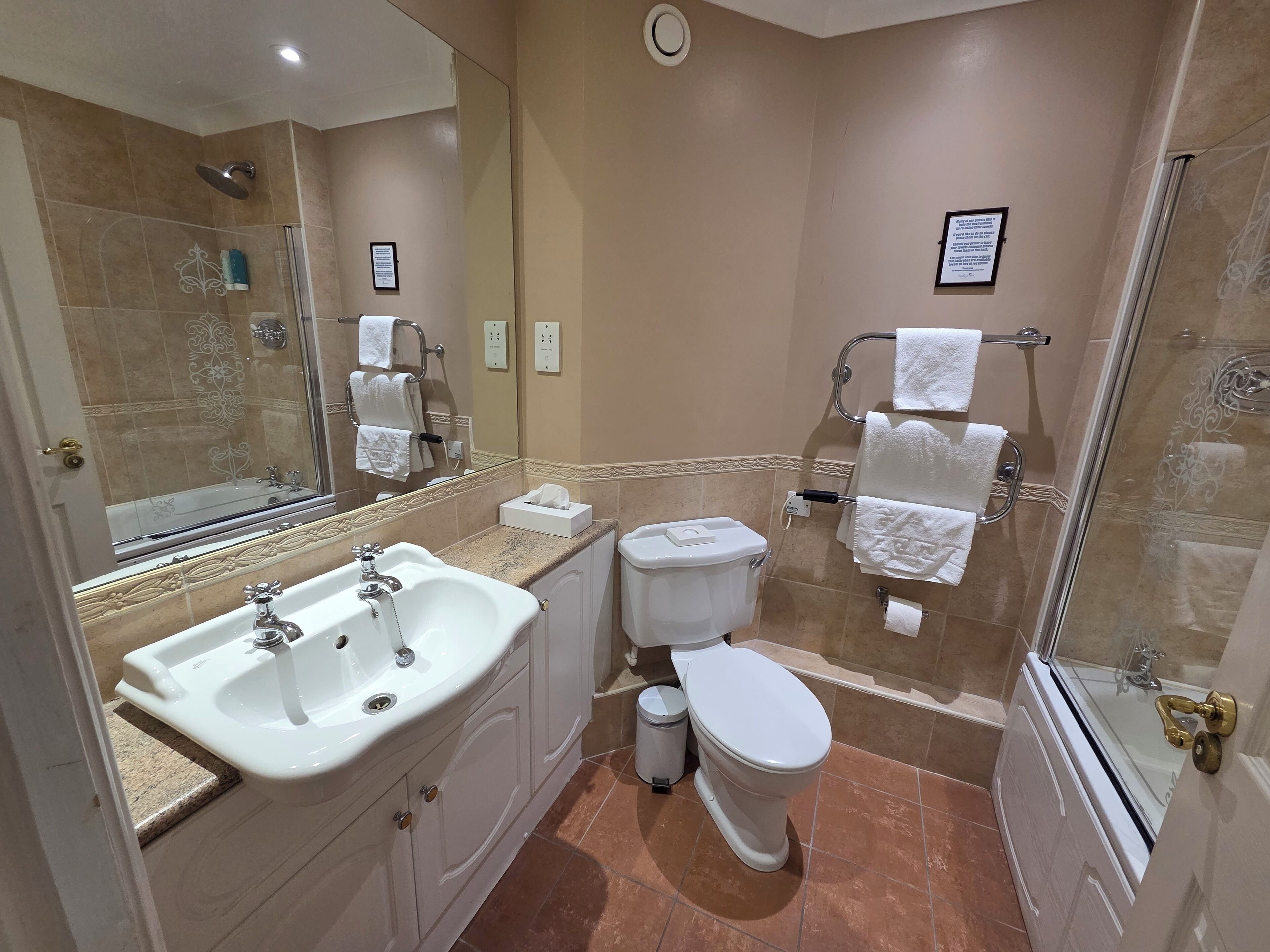 A bathroom with a sink, toilet, and shower.
