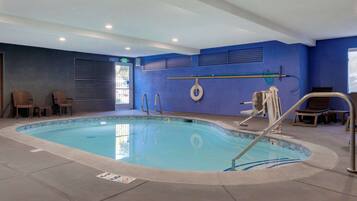 Relax by the pool, where a clear pool and comfortable seating await.