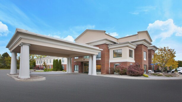 A two-story building with a covered entrance and a brick facade.