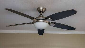 A ceiling fan with four blades and a light fixture.