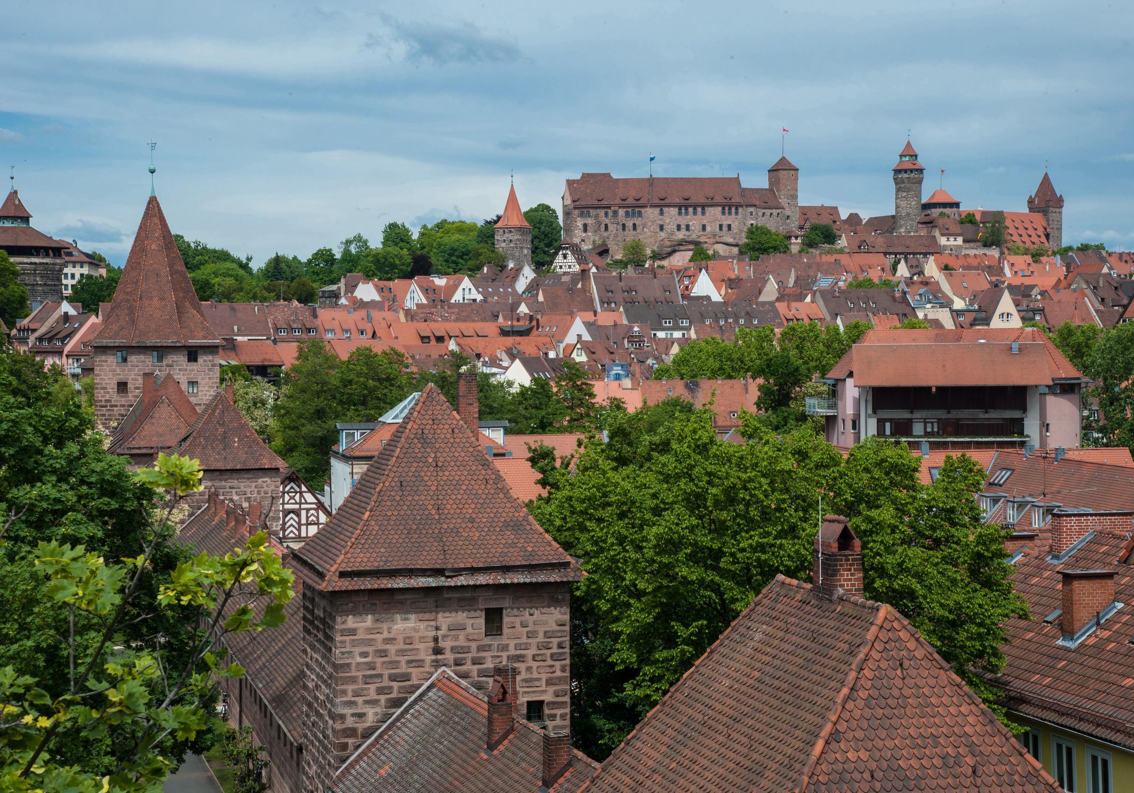 A historic town with traditional architecture, including a prominent castle and various buildings with steeply pitched roofs.