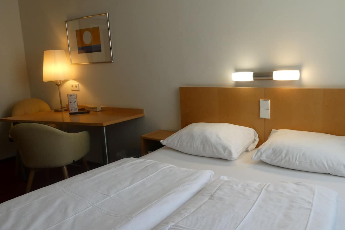 Desk, iron/ironing board, bed sheets