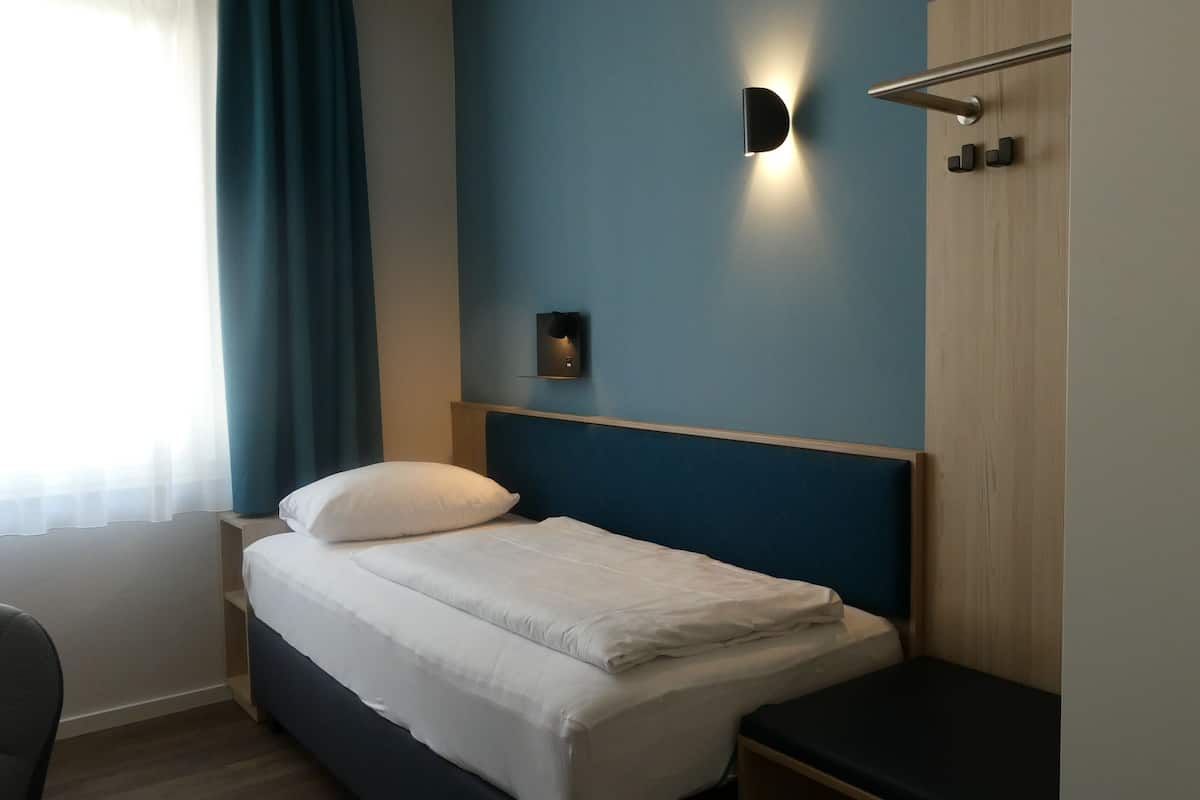 Desk, iron/ironing board, bed sheets