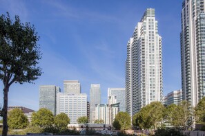 A cityscape with high-rise buildings, including a prominent skyscraper with a unique design. - Hilton London Canary Wharf (London)