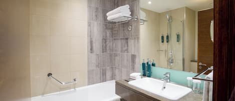 A modern bathroom with a bathtub, a sink, and a shower.