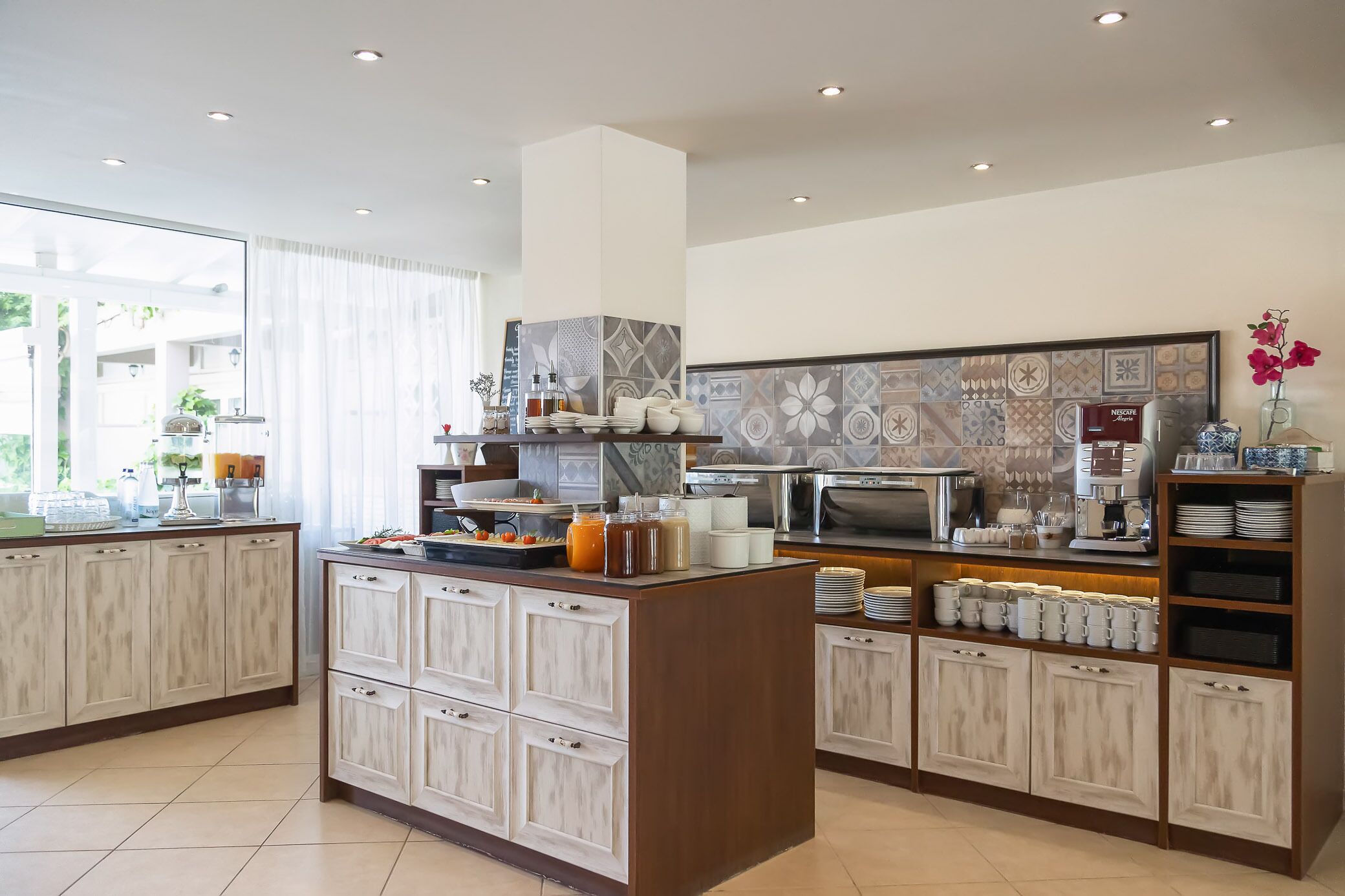A modern kitchen with a central island, built-in cabinets, and a microwave.