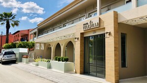 A hotel with a modern facade, arched balconies, and a clear sky. - Telesilla Hotel (Corfu)
