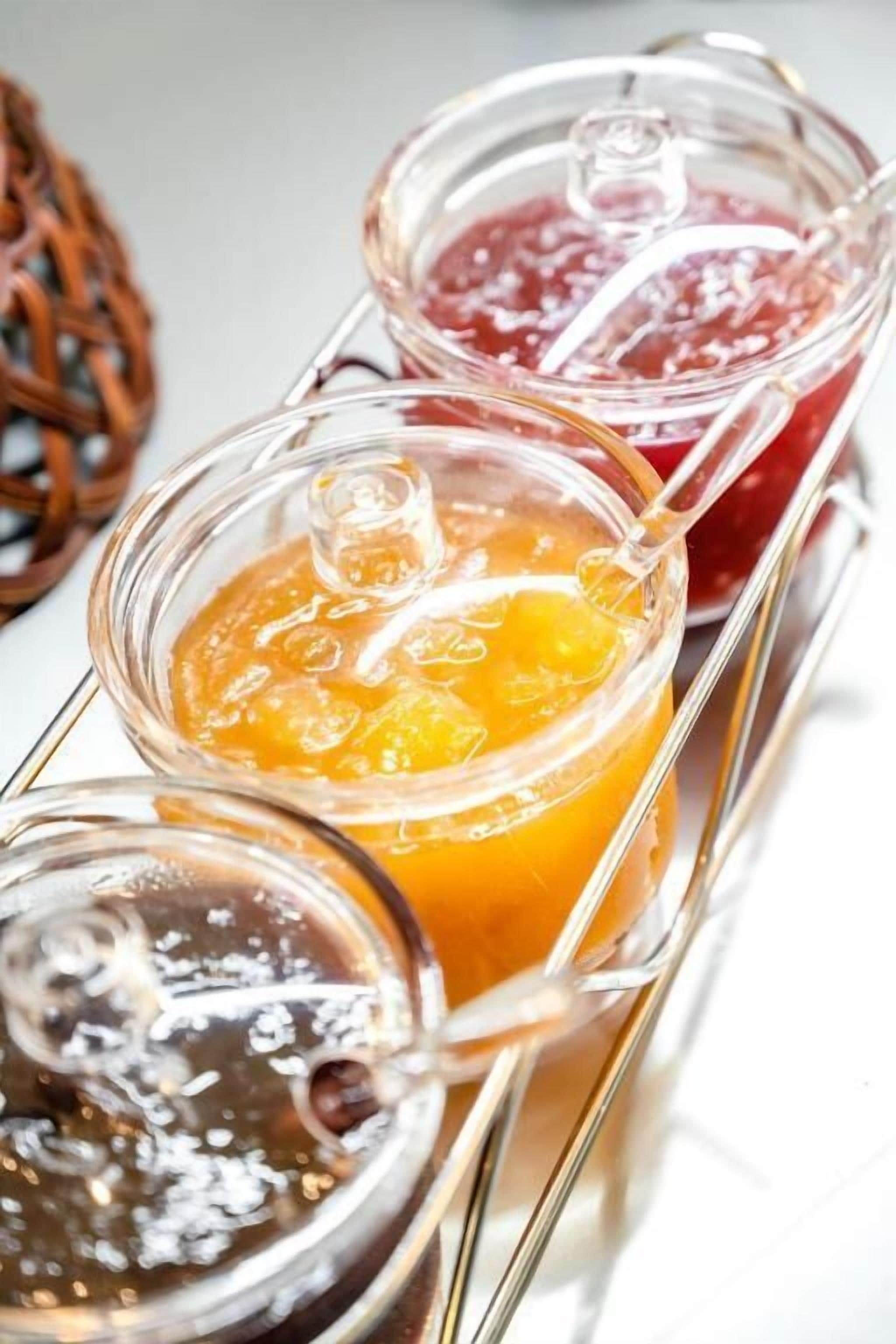 Three glass jars with different colored contents on a metal tray.