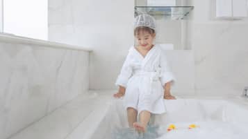 Bath time is a treat in this bathroom, complete with a bathtub and rubber ducks.