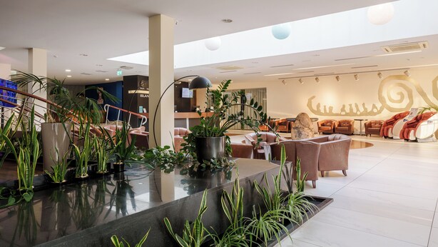 A spacious lobby with a reception desk, seating area, and potted plants. - Riga Islande Hotel with FREE parking (Riga)
