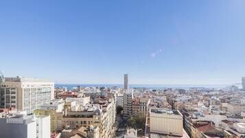 A cityscape with a variety of building types, including modern and older structures, under a clear sky.