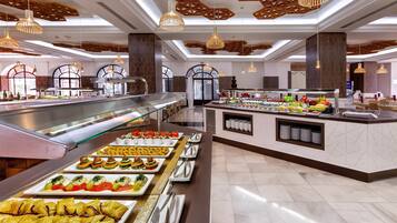 A buffet area with a variety of food options, a glass display case, and a counter with a beverage station.