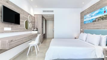 A modern bedroom with a large bed, a TV mounted on the wall, and a painting of a lighthouse.