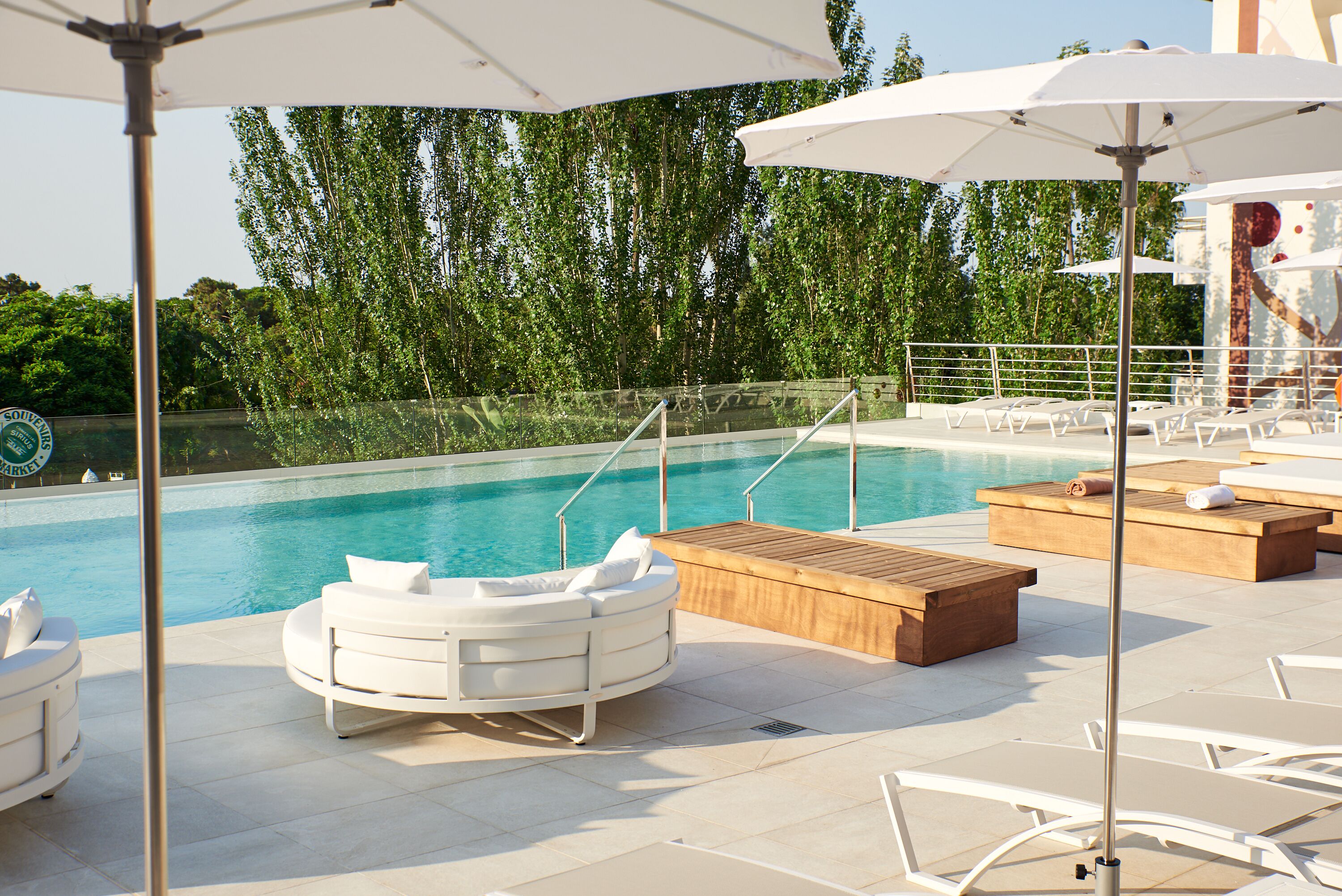 outdoor pool, open 9:00 am to 7:00 pm, pool umbrellas, pool loungers