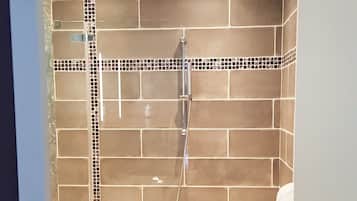 A bathroom with a shower, a bathtub, and a sink.