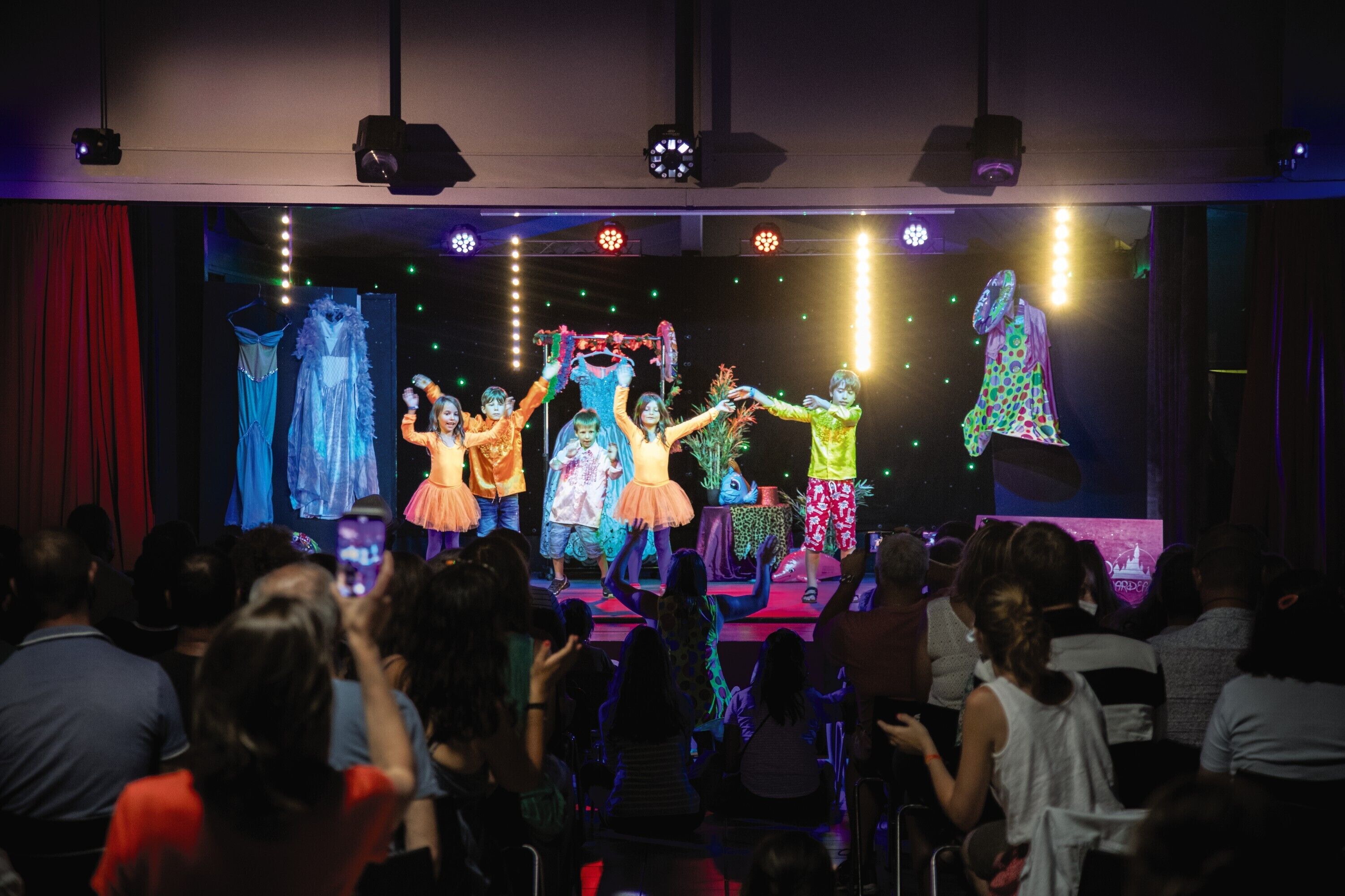 A stage performance with performers in colorful costumes.