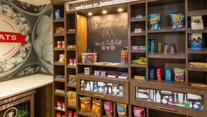 A snack display area with various packaged snacks and a chalkboard sign welcoming visitors to Jamestown. - Hampton Inn & Suites Jamestown (Jamestown)