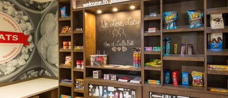 A snack display area with various packaged snacks and a chalkboard sign welcoming visitors to Jamestown.
