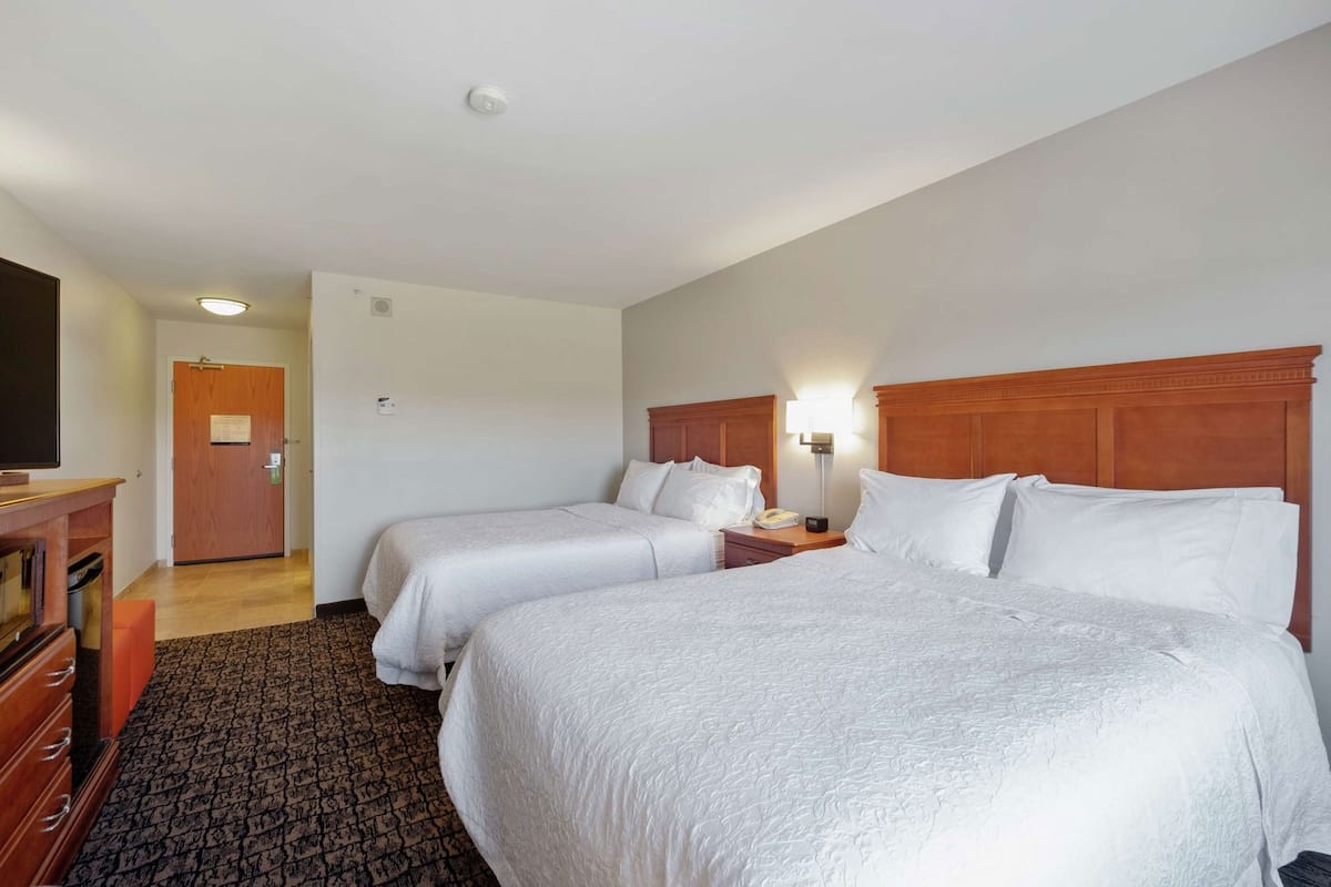 Hypo-allergenic bedding, down duvets, desk, laptop workspace